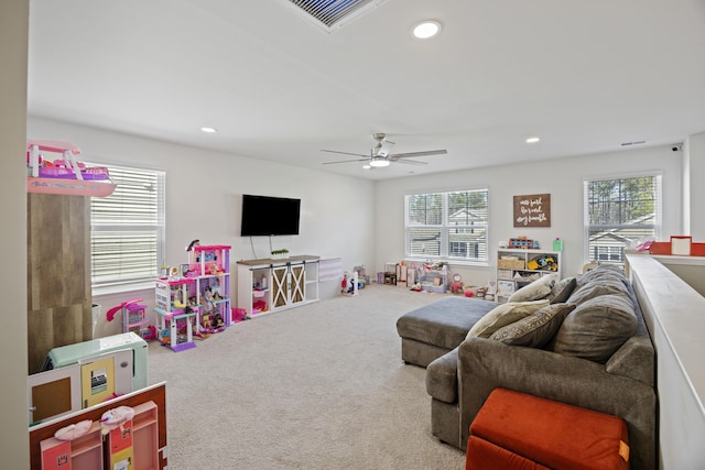 carpeted living area featuring plenty of natural light, a ceiling fan, and recessed lighting