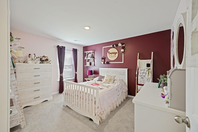 bedroom featuring baseboards, visible vents, and light colored carpet