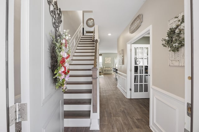 entrance foyer with recessed lighting, a wainscoted wall, a decorative wall, stairway, and dark wood finished floors