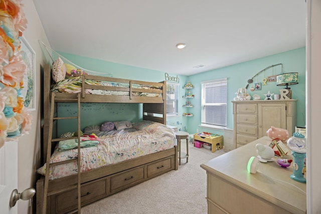 bedroom with light colored carpet and visible vents