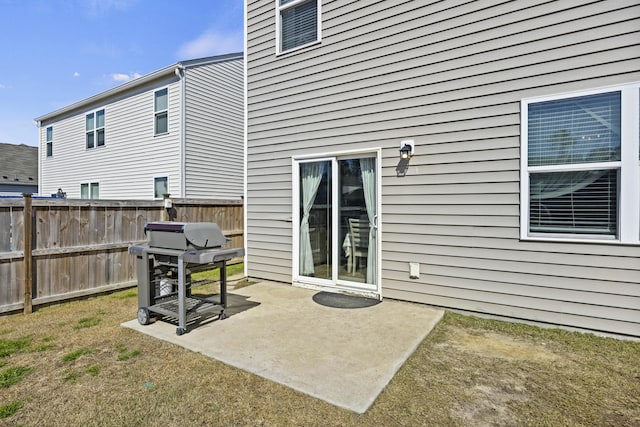 back of house with a patio and fence