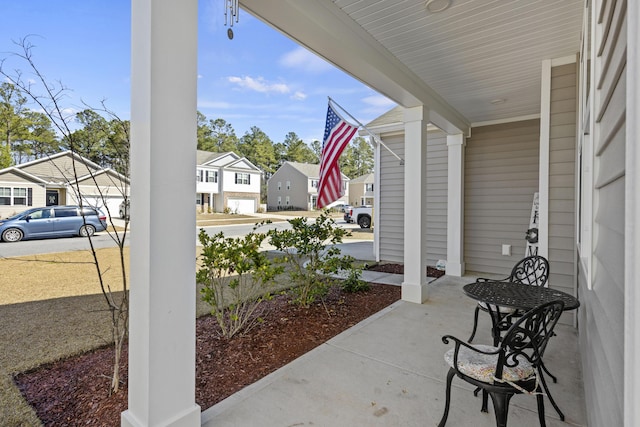 view of patio featuring covered porch and a residential view