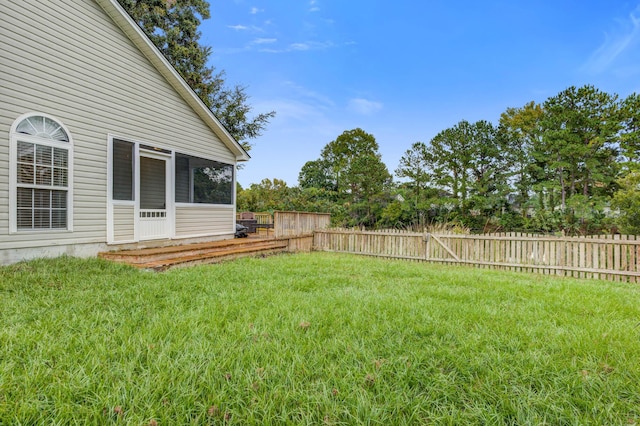 view of yard featuring a sunroom and fence