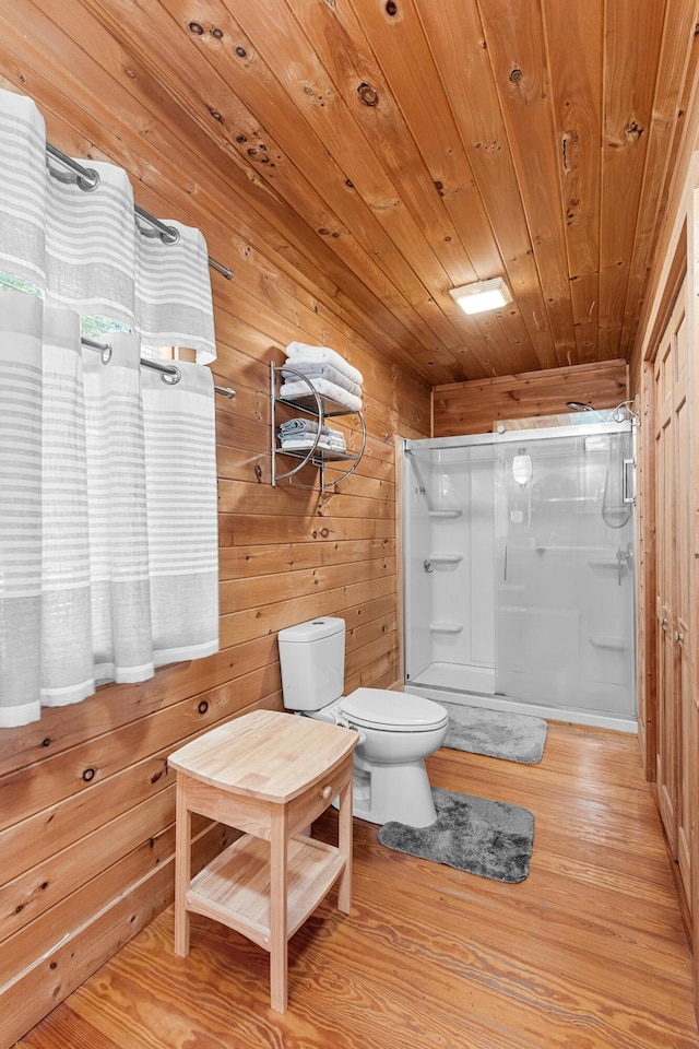 bathroom with toilet, an enclosed shower, wood ceiling, wooden walls, and wood finished floors