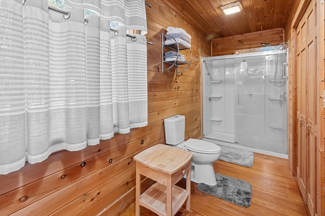 bathroom featuring wooden ceiling, toilet, wooden walls, wood finished floors, and a stall shower