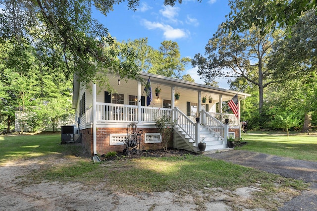 view of front of property featuring a porch, a front yard, and stairs