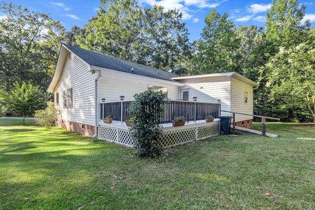 back of house featuring a shingled roof, crawl space, a wooden deck, and a lawn