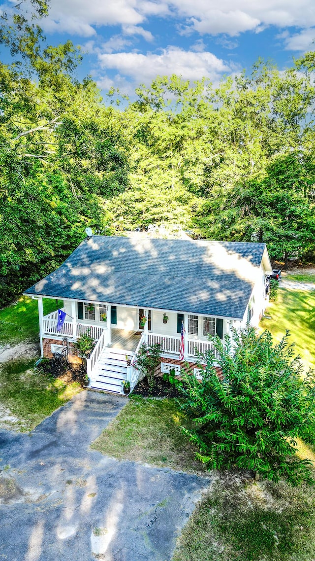 single story home with covered porch and aphalt driveway