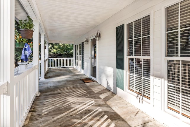 wooden terrace featuring radiator heating unit and a porch