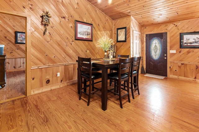 dining area with wood finished floors, wood ceiling, and baseboards