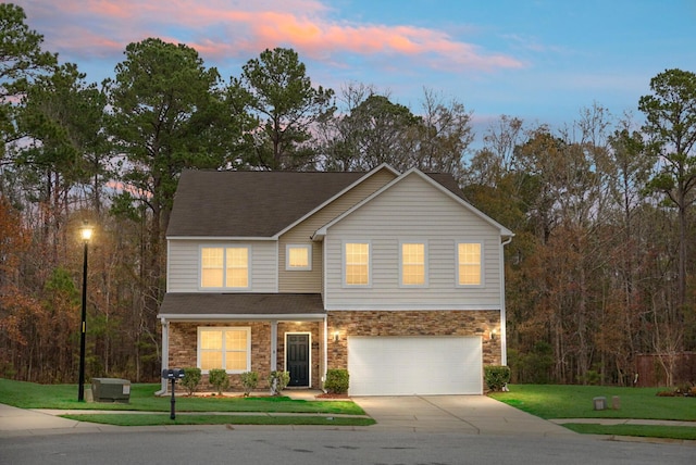 view of front of property featuring a lawn and a garage