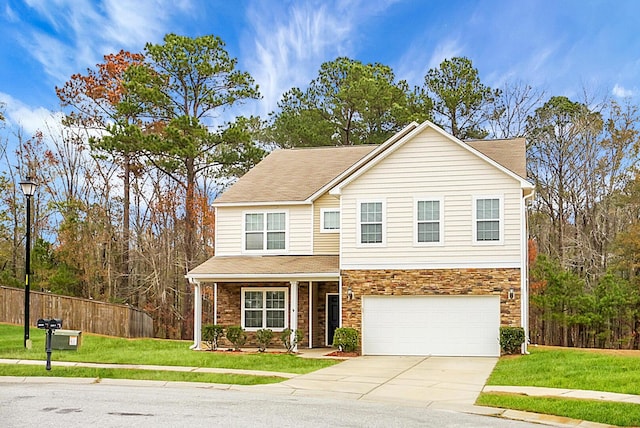 view of front of house with a front yard and a garage