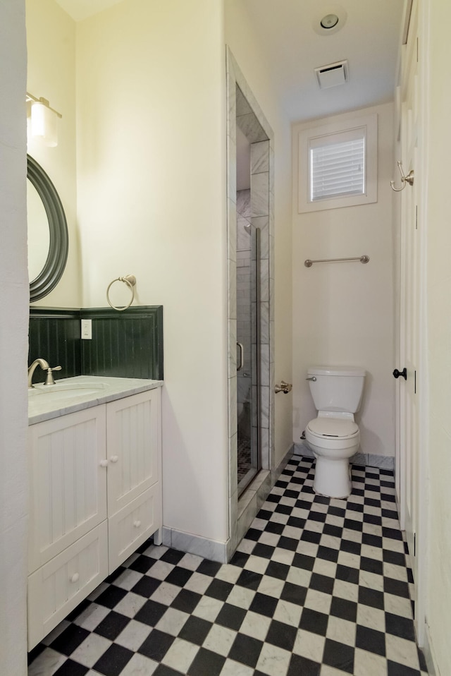 bathroom with vanity, toilet, tile patterned floors, and an enclosed shower