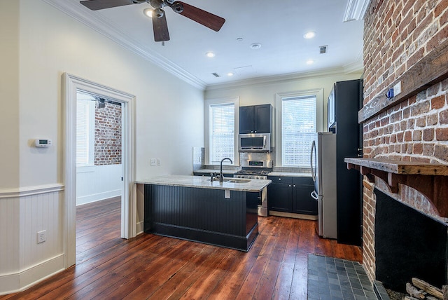 kitchen featuring ceiling fan, dark wood-type flooring, appliances with stainless steel finishes, and kitchen peninsula