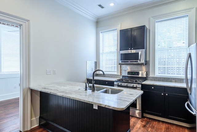 kitchen with dark hardwood / wood-style floors, decorative backsplash, kitchen peninsula, and stainless steel appliances