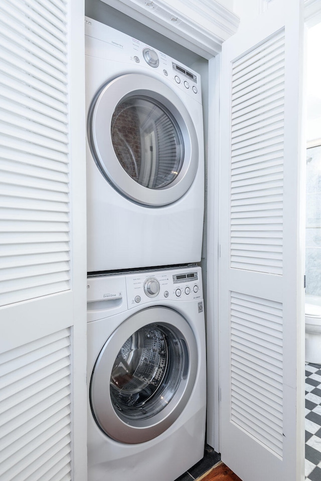 laundry area featuring stacked washing maching and dryer