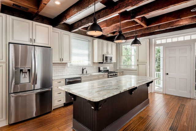 kitchen with beam ceiling, stainless steel appliances, dark hardwood / wood-style floors, pendant lighting, and sink