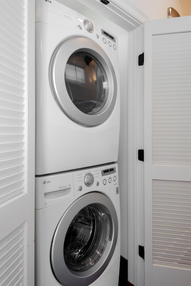 laundry room with stacked washer / dryer