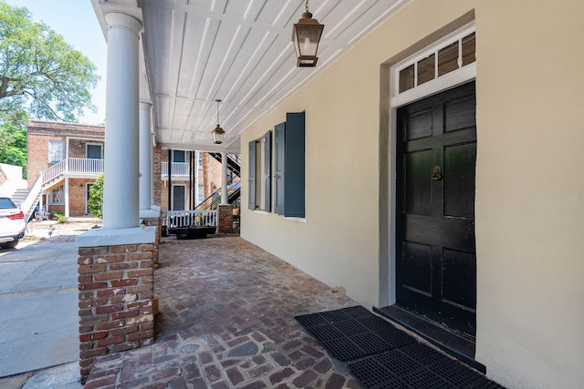 view of exterior entry with covered porch