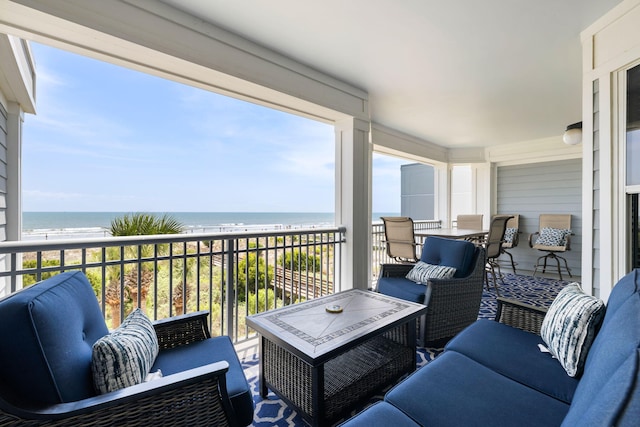 balcony featuring a view of the beach, a water view, and outdoor lounge area