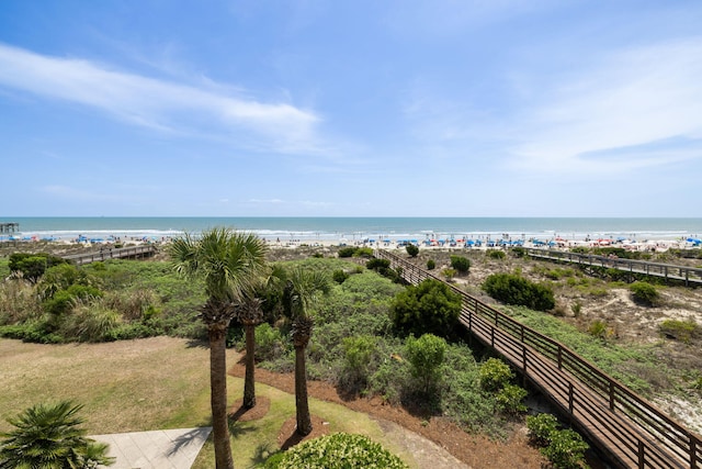 view of water feature featuring a beach view and fence