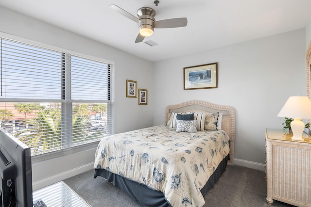carpeted bedroom with baseboards, ceiling fan, visible vents, and multiple windows