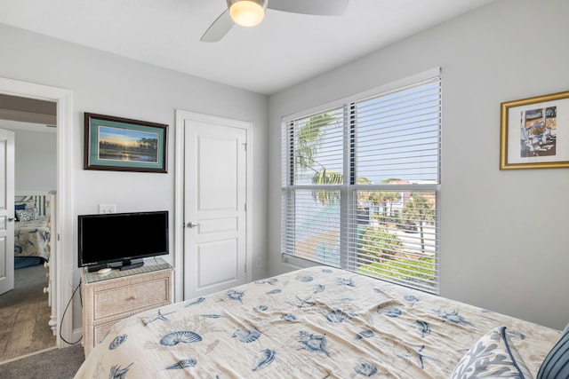 carpeted bedroom with baseboards and ceiling fan