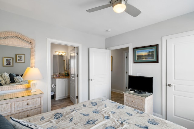 bedroom featuring connected bathroom, ceiling fan, and wood finished floors