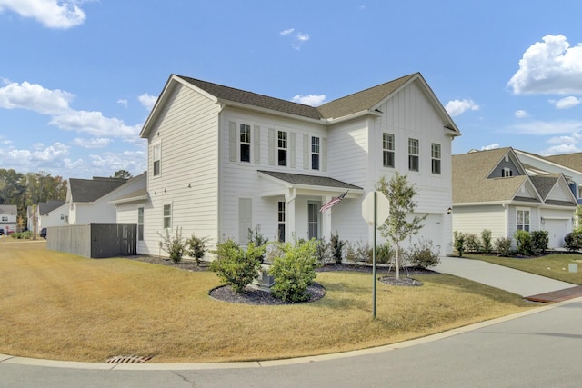 view of property with a garage and a front lawn