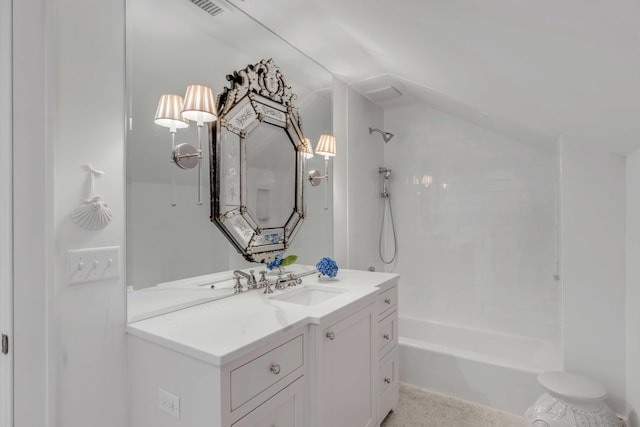 bathroom featuring tiled shower / bath and vanity