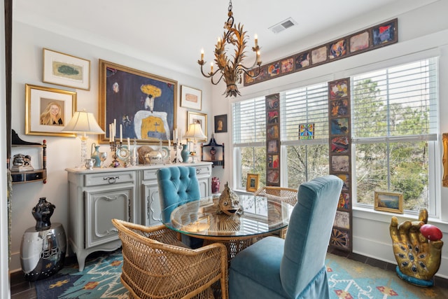 dining space with visible vents, baseboards, and an inviting chandelier