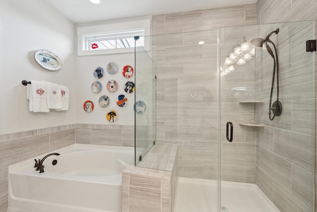 bathroom with a shower stall and a bath