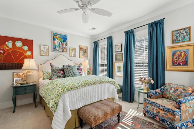 carpeted bedroom with visible vents, baseboards, and ceiling fan