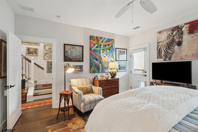 bedroom featuring visible vents, baseboards, dark wood-type flooring, and a ceiling fan