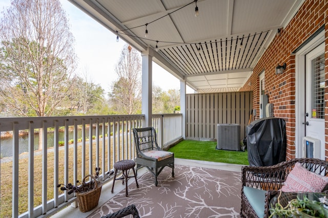 view of patio / terrace with central air condition unit and area for grilling