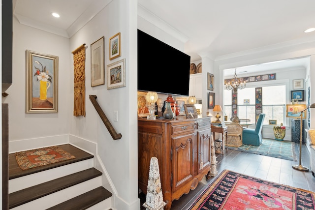 interior space featuring stairway, ornamental molding, recessed lighting, wood finished floors, and a notable chandelier