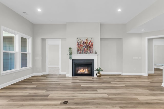 unfurnished living room featuring light wood-type flooring