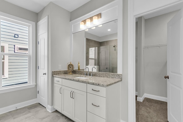 bathroom with vanity and a shower with shower door