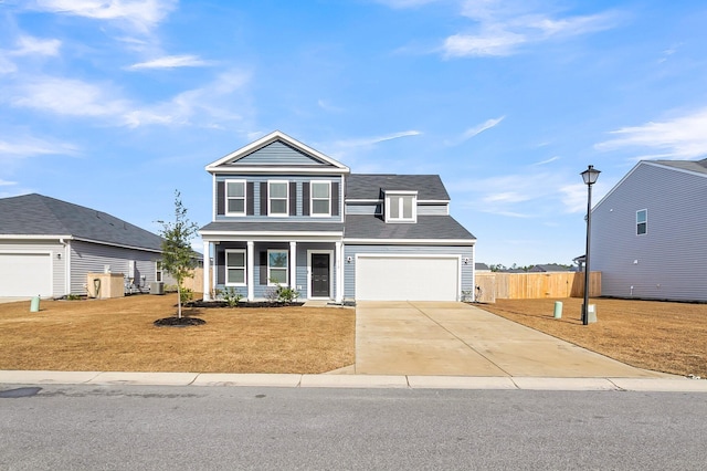 front facade featuring a porch, a garage, central AC unit, and a front lawn