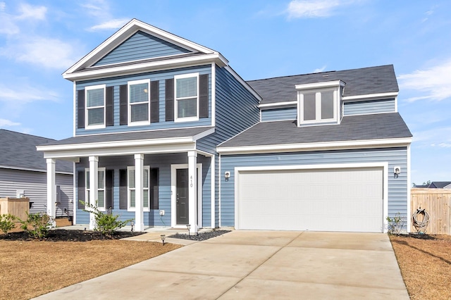 view of front of home featuring a porch and a garage