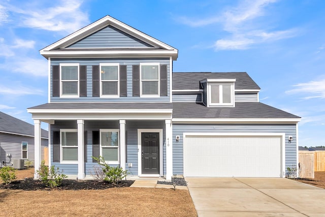 view of front of property with cooling unit, a garage, and a porch