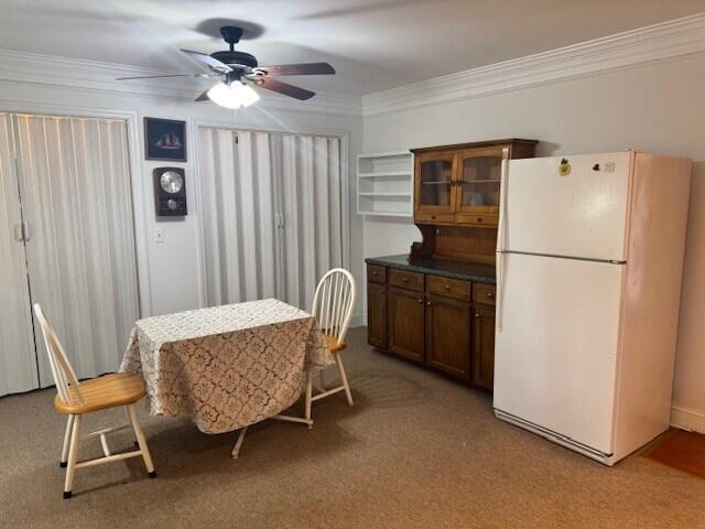 1089 Charles Dr, Manning, SC 29102 - dining space featuring a ceiling fan, crown molding, and light carpet