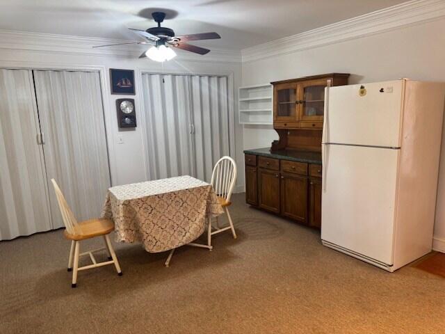 1089 Charles Dr, Manning, SC 29102 - dining area featuring a ceiling fan, ornamental molding, and light carpet