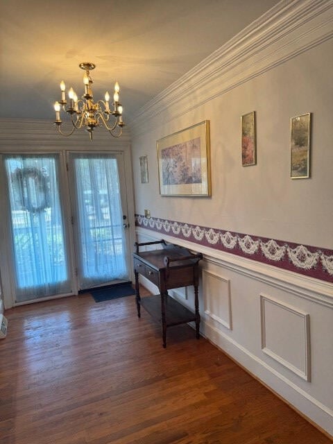 1089 Charles Dr, Manning, SC 29102 - foyer featuring a chandelier, crown molding, dark wood-style flooring, and wainscoting