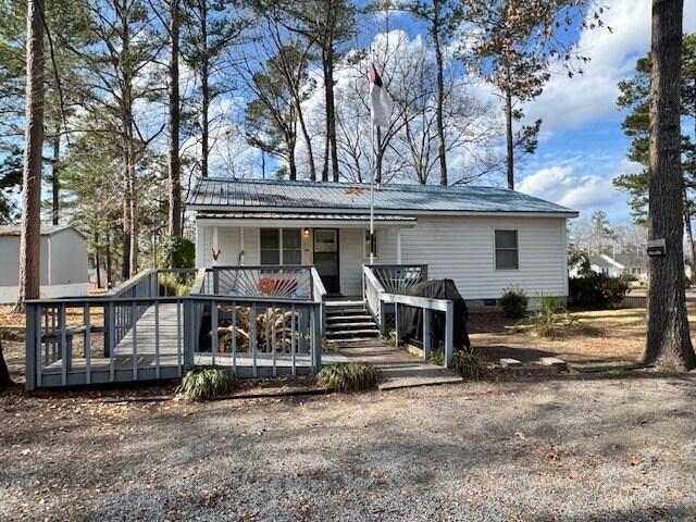 1089 Charles Dr, Manning, SC 29102 - view of front facade featuring a porch, crawl space, and metal roof