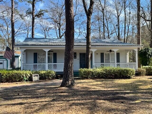 1089 Charles Dr, Manning, SC 29102 - view of front of home featuring a porch, a ceiling fan, metal roof, and a shed