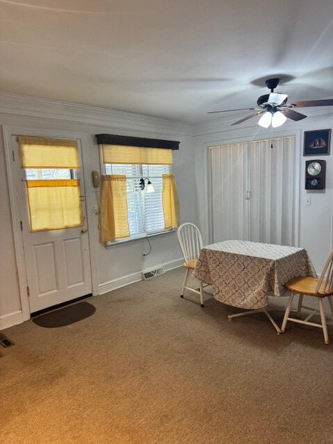 1089 Charles Dr, Manning, SC 29102 - carpeted dining room with baseboards and ceiling fan
