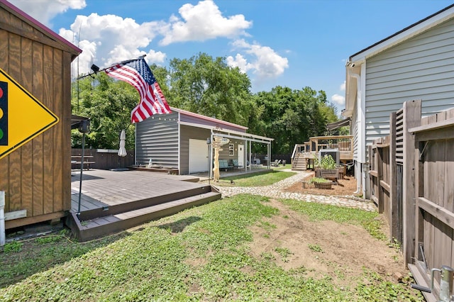 view of yard with a deck and an outdoor structure