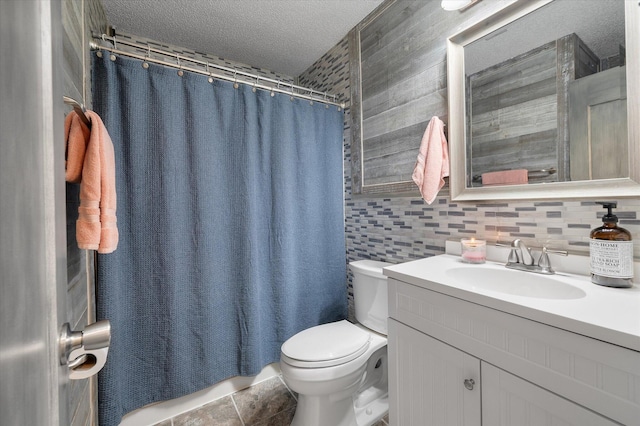 bathroom featuring a textured ceiling, toilet, vanity, a shower with shower curtain, and tile patterned flooring