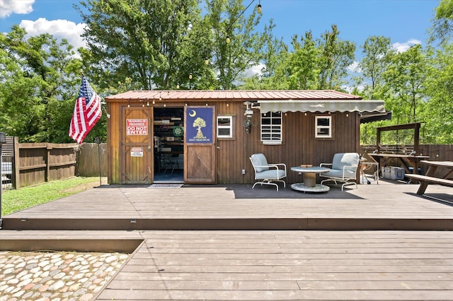 deck featuring fence and an outdoor structure